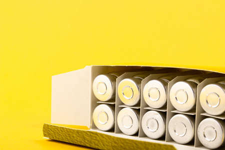 Bubbles, ampoules with dry probiotic, bifidobacteria, with probiotic powder inside on a yellow...
