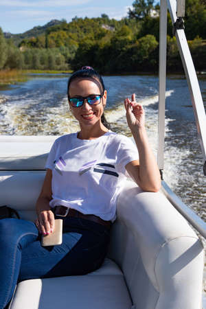 Happy caucasian beautiful woman on the pine forest of a luxury yacht. Pretty sexy fashion model....