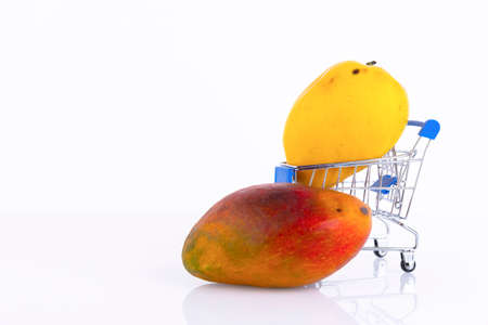 Various types of mango with yellow, red peel, a favorite Thai fruit in a shopping cart, on a white background. ECO, environmentally friendly product. Copy space.の写真素材