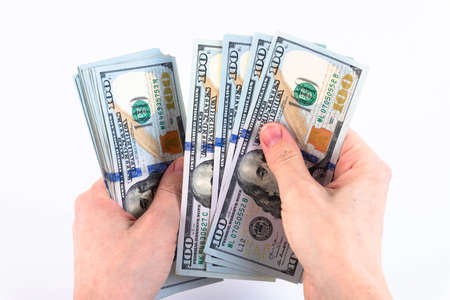 Woman's hands, count money, American one hundred dollar bills. Isolated on white. Copy space.