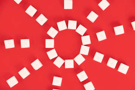 Background, cubes of sugar on a red background.
