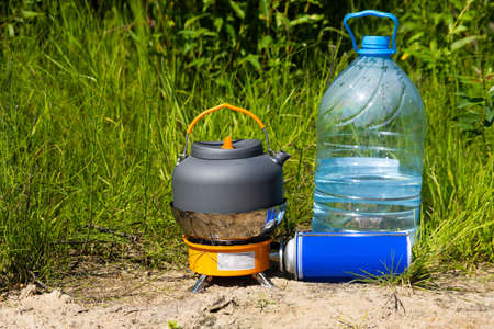 Picnic in nature. A gas burner and a mug of hot tea.