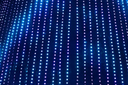 Christmas background, glowing multicolored neon lights. Copy space. Out of focus