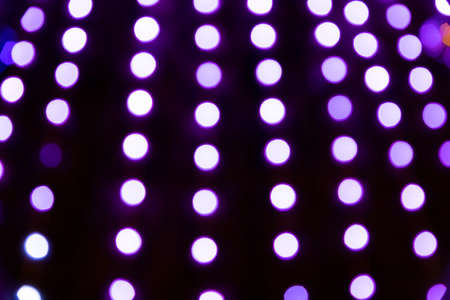 Christmas background, glowing multicolored neon lights. Copy space. Out of focusの写真素材