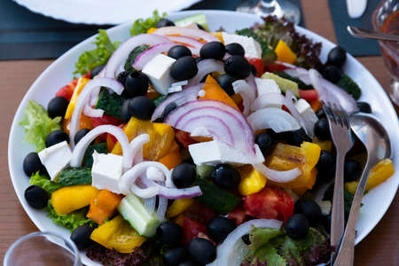 Vegetable salad, appetizer, with cheese, olives, red onion, tomato and pepper. Greek salad. Selective focus.の写真素材