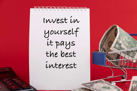 Invest in yourself it pays the best interest, the text of the is written in a white notepad red background.の写真素材