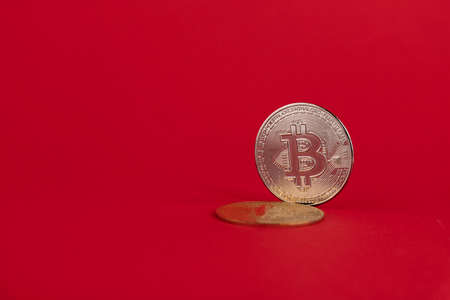 Bitcoin coin, crypto money on a red background. Copy space.の写真素材