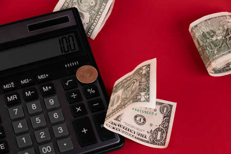Cash, calculator scattered on a red background. Copy space.の写真素材