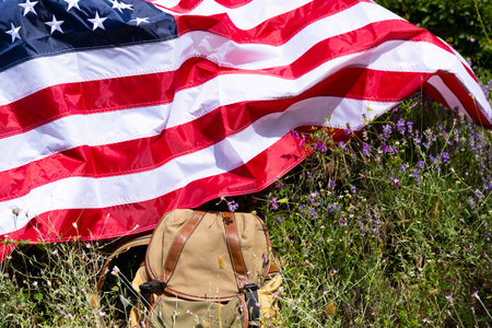 Tourist backpack and USA flag on lavender field, no people.の写真素材