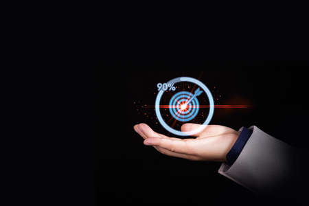 Businessman holding target dartboard with download icon progress for business achievement concept. High quality photoの写真素材