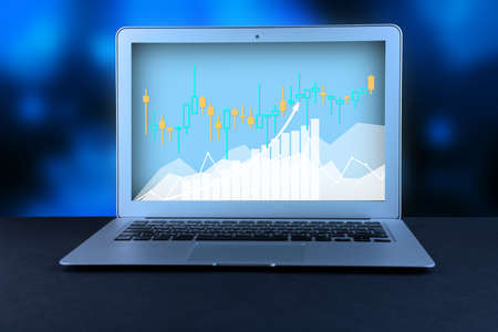 .Laptop on office desktop, business chart and diagram with abstract background, computer analysis of...