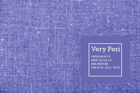 Linen fabric texture with color coded leather label, in purple toned color Very Peri. Trendy color...