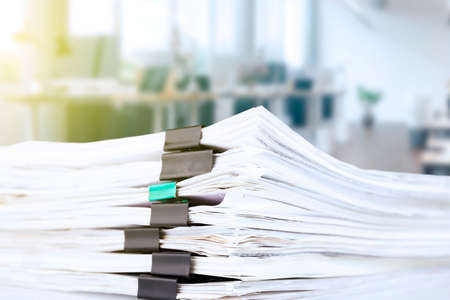 stack of reporting paper documents on a business table in the office, business documents for annual reports. business analytics. Business office concept, soft focus. high quality photoの写真素材