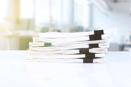 stack of reporting paper documents on a business table in the office, business documents for annual reports. business analytics. Business office concept, soft focus. high quality photoの写真素材