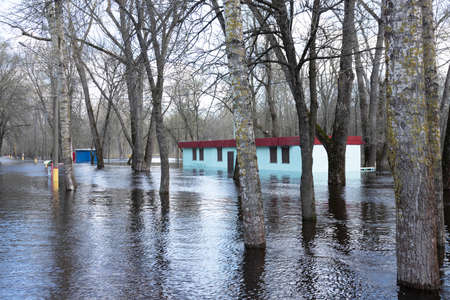 Spring flood on a river in Europe as a result of seasonal snowmelt and groundwater rise, flooding of buildings. high quality photoの写真素材