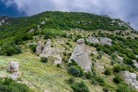 Mountain landscape, stone pillars in the form of ghosts, stone idols in a mountain valley, a canyon against the sky.の写真素材