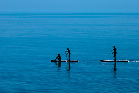 A group of people are riding a SUP board. Hobby, leisure, sports