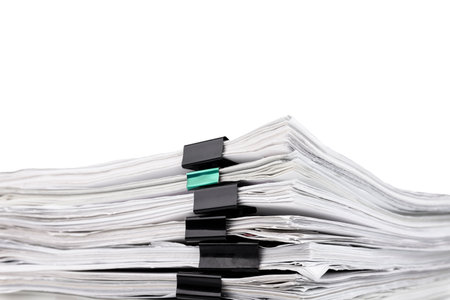 Stack of papers with paper clips, office folders. White isolated background.の写真素材