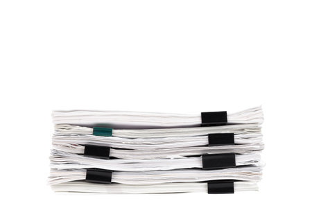 Stack of papers with paper clips, office folders. White isolated background.