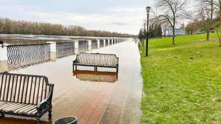 Spring floods, flooded paths and benches in the park.の写真素材