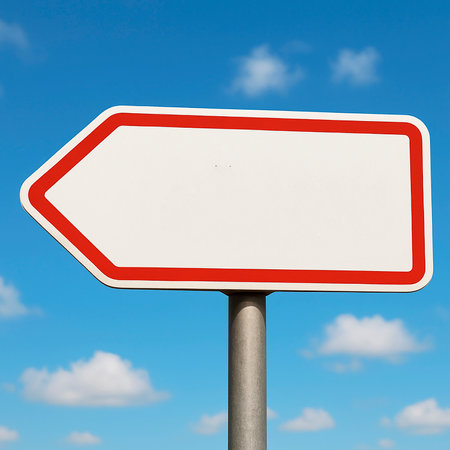 Road sign pointing left, white plate against blue sky, copy space.