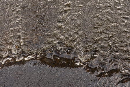 The flow of water in the Elbe River near Dresden. View from above. Water background