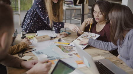 Young creative business team in modern office. Multiethnic group of people working on architectural design together.の写真素材
