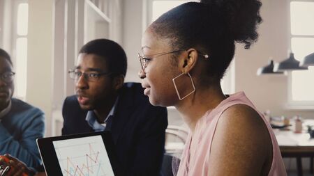 Multiracial trading company board meeting. Young happy creative employees brainstorming in modern light office space 4K.の写真素材