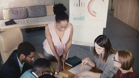 African American woman boss motivates colleagues. Successful businesswoman gives directions at office team meeting 4K.の写真素材
