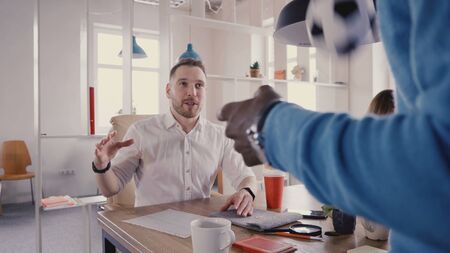African American employee talks to friendly CEO. Mixed race business people smile, work in healthy office atmosphere 4K.の写真素材