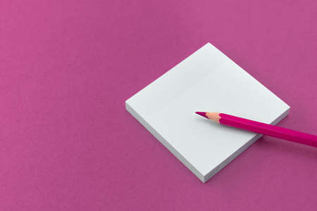 Pencil and Notepad for notes and notes are on a colored backgroundの写真素材