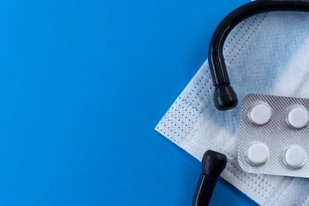 Stethoscope and pills on blue background, top view. Space for textの写真素材
