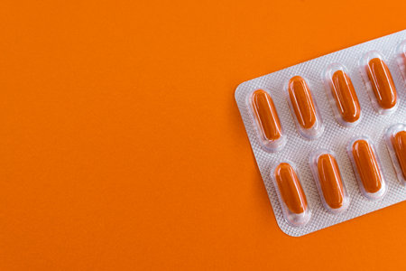Capsules in a blister pack on an orange background. copyspace.の写真素材
