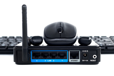 Wireless dial, router, headphones, mouse and keyboard on white