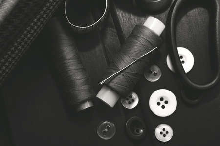 Needle and thread. Scissors and cloth. Tools for the work of a fashion designer, seamstress and...