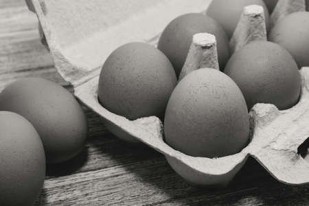 Egg. Chicken eggs in an organic box on a wooden table. Black and white photographyの写真素材