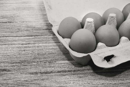 Egg. Chicken eggs in an organic box on a wooden table. Black and white photography