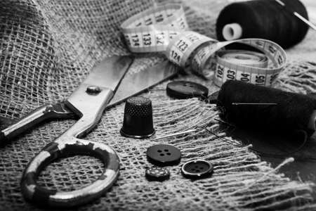 Needle and thread. Scissors and a centimeter are the tools of a tailor, fashion designer,...