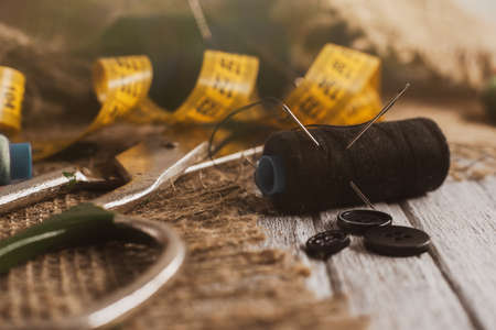 Sewing Thimble. Needle and thread. Scissors and a centimeter are the tools of a tailor, fashion designer, seamstressの写真素材