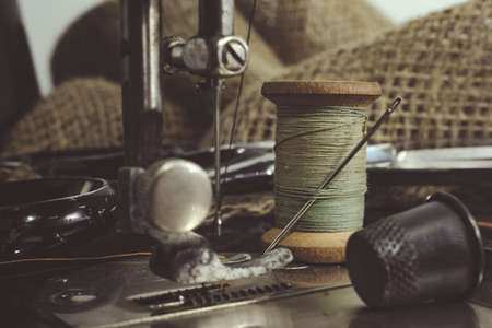 Needle and thread, scissors, sewing machine. Tailor's, fashion designer's, and seamstress's tools....