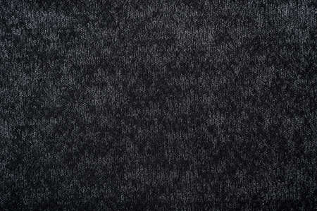 Cloth. The background is made of dark colored fabric. A texture or pattern from a material. A piece...