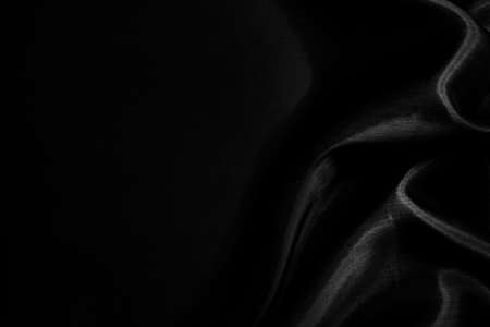 Part of the dark fabric texture of the fabric for the background and decoration of the work of art, a beautiful crumpled pattern of silk or linen. A crumpled piece of clothの写真素材