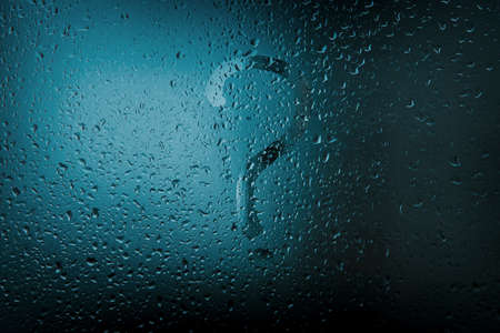 A question mark on rain-wet glass. Water drops on the window. Question symbolの写真素材