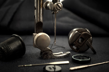Old retro sewing machine, needle with thread, scissors and thimble. Tailor, seamstress and fashion...