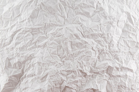 Background from crumpled white paper close-up. Pleated paperの写真素材