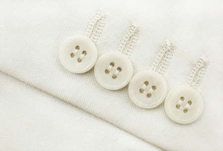 Buttons on white clothes. Element of men's clothing. Sleeve with buttons men's suitの写真素材