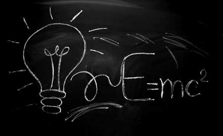 board with chalk. The equation for the energy of light is written on the blackboard with chalk....