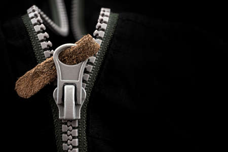 Lock with a gray zipper on black clothes close-up. jacket claspの写真素材