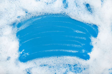 Soap foam. Background of dusty foam with bubbles of blue color for an inscription. Soap sud with...
