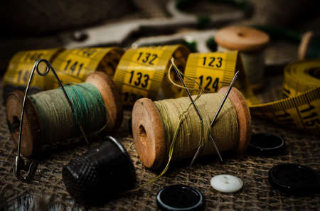 Retro tools for cutting and sewing. Needle with thread, thimble, sewing machine and scissors